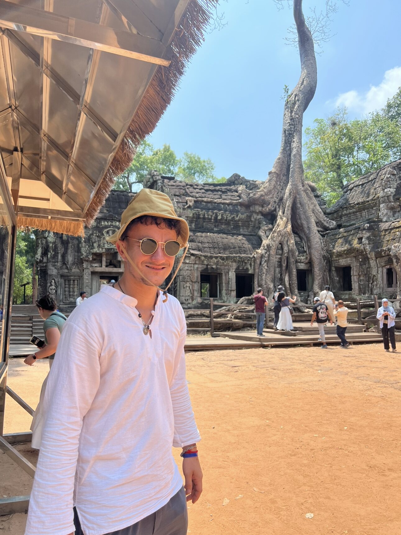 Ollie exploring the tree-covered ruins of Ta Prohm in Cambodia